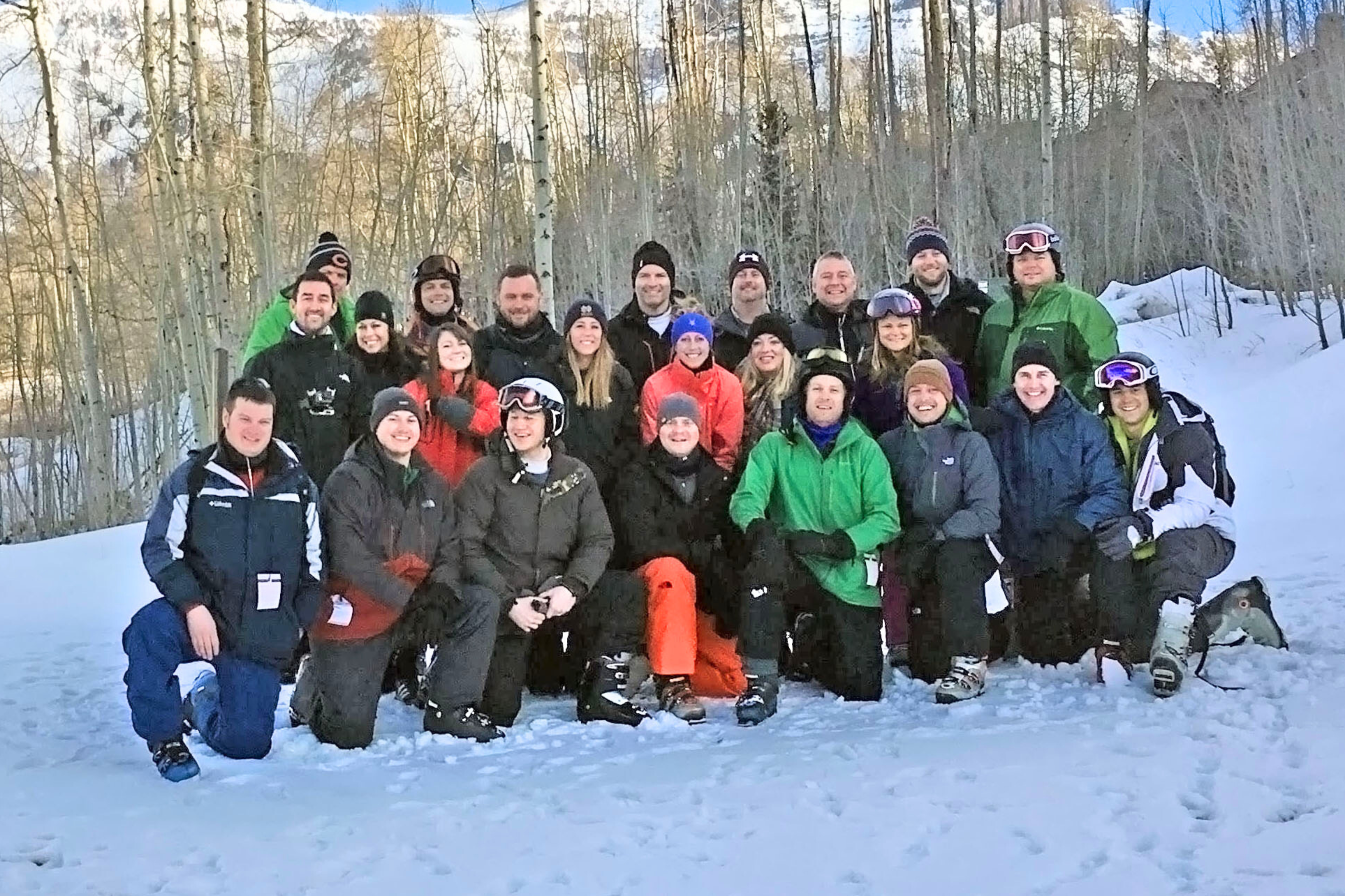 a group of people posing for a photo in the snow