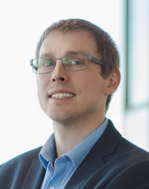 a man wearing glasses and a suit