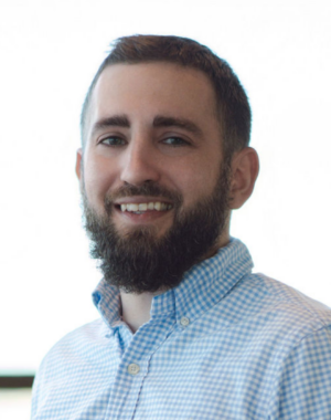 a man with a beard smiling