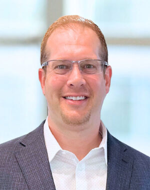 a man wearing glasses and a suit