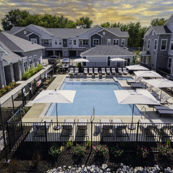 a pool with umbrellas and chairs in a resort