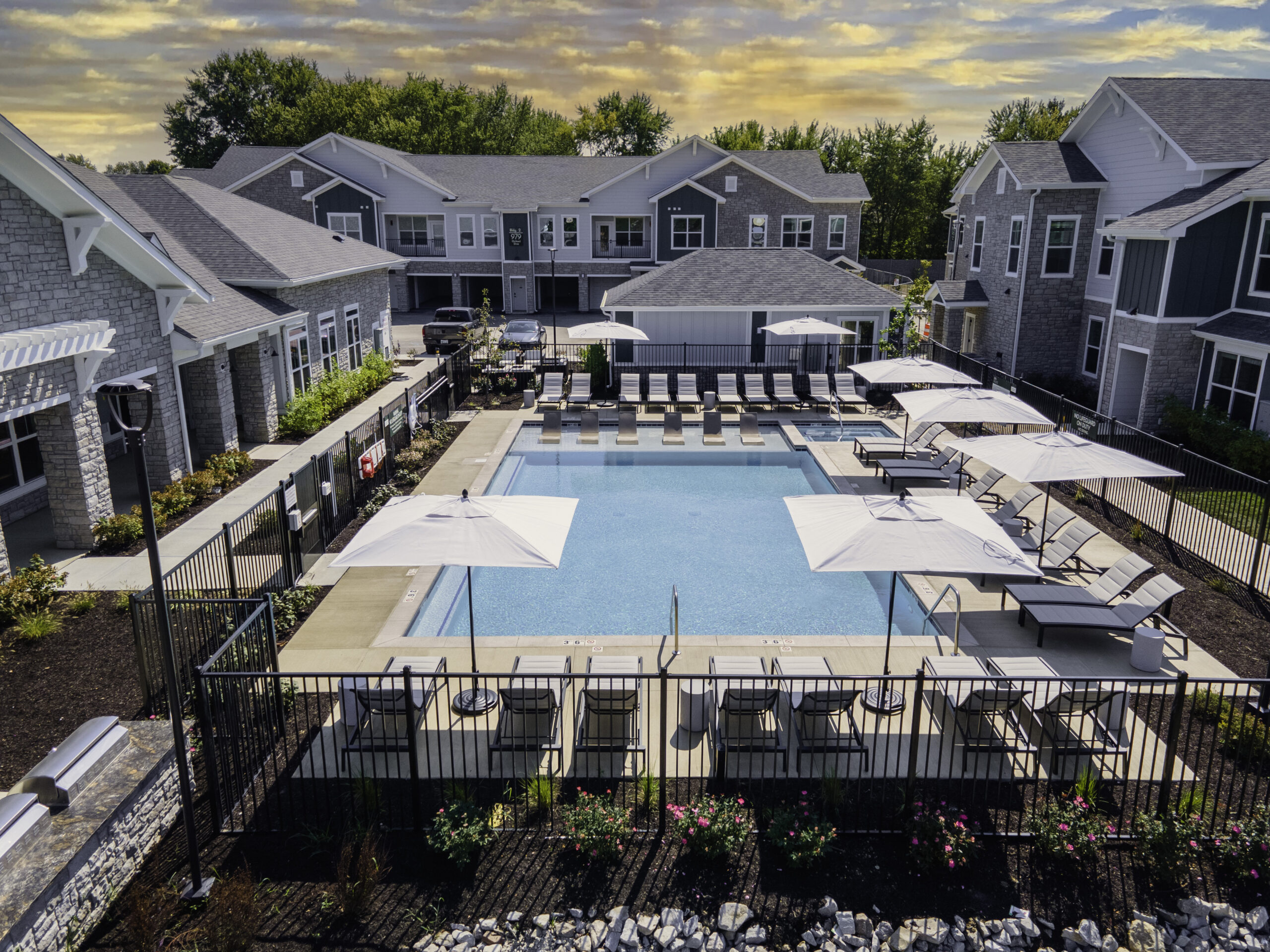 a pool with umbrellas and chairs in a resort