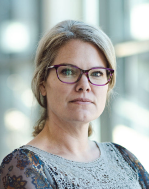 a woman wearing glasses and a lace top