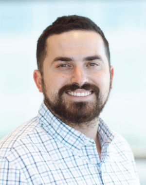 a man with a beard and mustache smiling