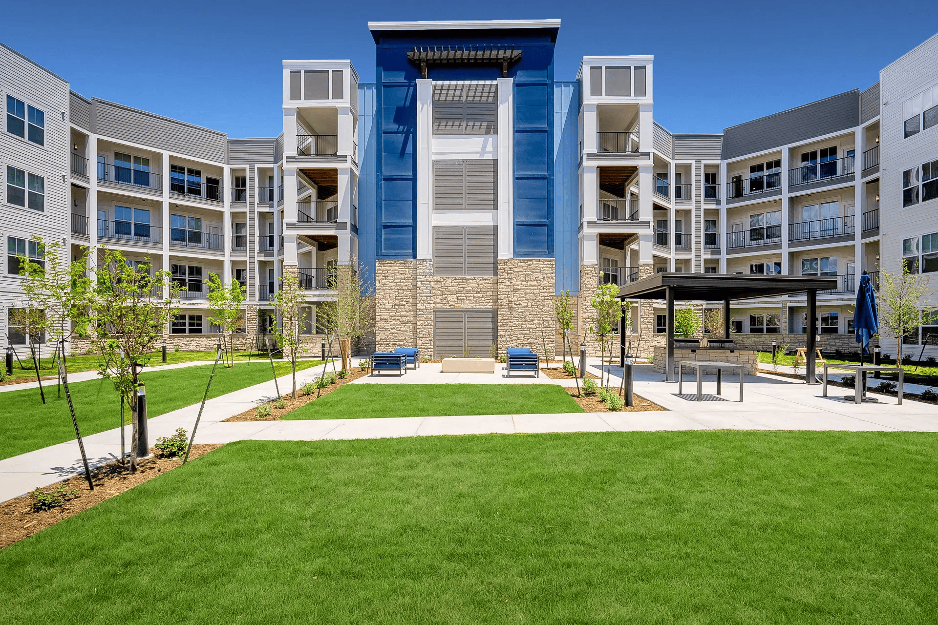 a building with a lawn and a blue wall