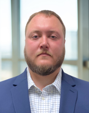 a man with a beard wearing a blue suit