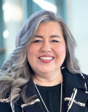 a woman with long gray hair smiling